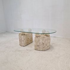 two stone and glass coffee tables in an empty room