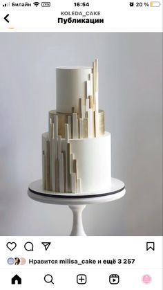 a three tiered cake with white icing and gold decorations