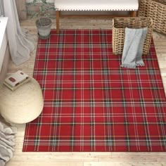 a red plaid rug in the corner of a room