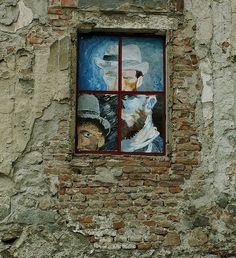 an old brick building with two windows on the side and one window in the middle