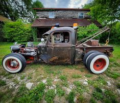 an old truck parked in front of a house