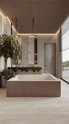 a large bath tub sitting in the middle of a bathroom next to a planter