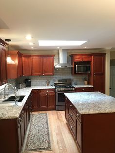 a kitchen with wooden cabinets and granite counter tops