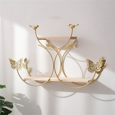 a wall shelf with two butterflies on it