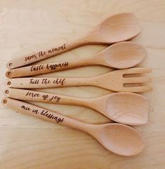 five wooden spoons with words on them