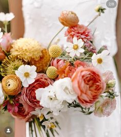 a bride holding a bouquet of flowers in her hands