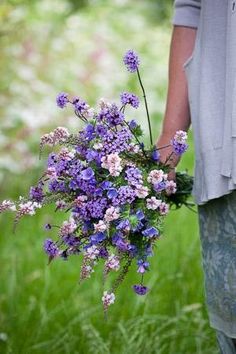 a person holding a bunch of flowers in their hands