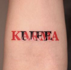 the word kareea written in red and black ink on someone's arm