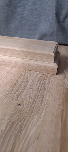 a close up of a wooden floor with a person standing next to it