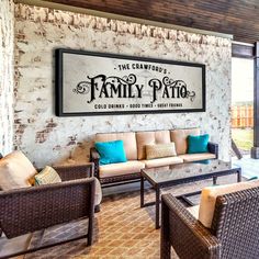 a living room with wicker furniture and a sign on the wall that says family patio