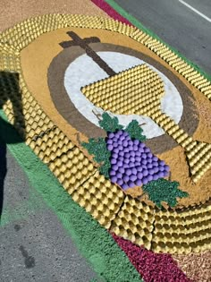 a mosaic with grapes and a cross on it