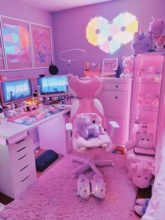 a bedroom with pink walls and lots of stuffed animals on the floor in front of two computer desks