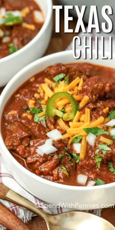 two white bowls filled with chili and cheese