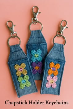 three denim keychains with crochet flowers on them and the words, chapstick holder keys chains