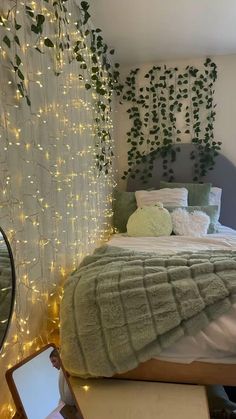 there is a bed with lights on the headboard and pillows in front of it