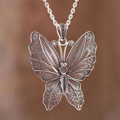 The wings of a beautiful nocturnal butterfly are captured in sterling silver featuring marvelous handcrafted filigree openwork. Nancy Quispe of Peru who designs the necklace works in the hope of opening a school for young artisans. Filigrana Jewelry, Filigree Pendant Necklace, Bridesmaid Pearls, Filigree Necklaces, Filigree Jewelry, Goth Jewelry, Silver Jewelry Design, Roman Glass, Filigree Pendant