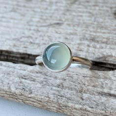 A beautiful solitaire luminescent light aqua chalcedony stone has been set in sterling silver to create this simple and elegant ring. The ring band is sterling silver half dome wire and handmade. Each chalcedony color catches the light and has a soft look. The stone is 8mm in size. Made to order! Soft Silver Jewelry, Engagement Ring Simple Silver, Aqua Chalcedony Ring, Hematite Ring, Blue Gemstone Rings, Silver Rings With Stones, Chalcedony Stone, Chalcedony Ring, Ring Birthstone