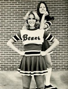 two women in cheerleader outfits standing next to each other with their hands on their hipss