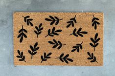 a door mat with black leaves on it