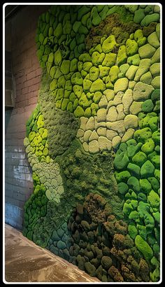 a green wall with rocks and grass on it