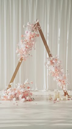 an artistic display with pink flowers and candles