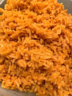 a bowl filled with lots of rice on top of a table