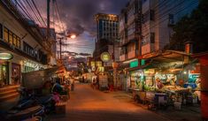 an empty street at night with many vendors