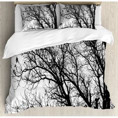 black and white photograph of trees in the snow on a duvet cover set with pillow cases