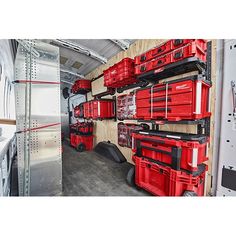 the inside of a van with red tool boxes