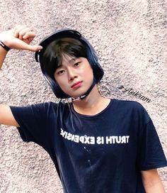 a young boy wearing a helmet with the words truth is expensive on it's t - shirt