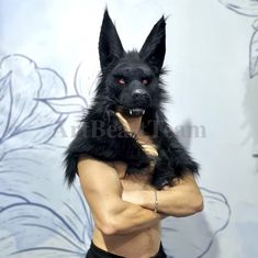 a man with a dog on his chest posing for a photo in front of a wall