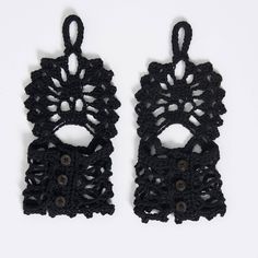 pair of black crocheted earrings with buttons