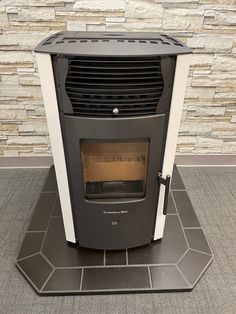 a fireplace with a heater sitting on top of it