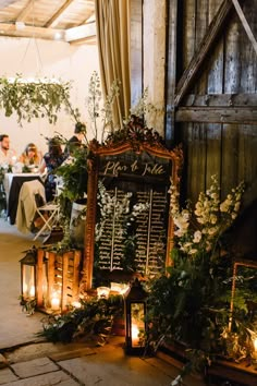 a chalkboard sign surrounded by candles and greenery