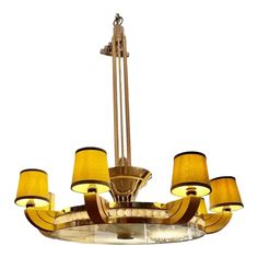 a chandelier with yellow shades on the top and bottom lights hanging from it