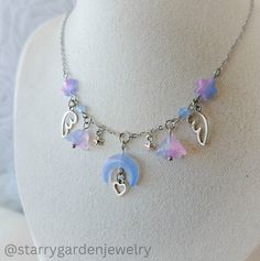 * Pastel Moon and Flowers Charm Necklace * Made with pastel star and flower beads, delicate angel wings, and a charming crescent moon centerpiece, adorned with a tiny heart.  ❀ Materials: Stainless steel, glass beads and zinc alloy charms.  ❀ Length: 42 cm.  ➤ 𝘑𝘦𝘸𝘦𝘭𝘳𝘺 𝘊𝘢𝘳𝘦 ❀ Please handle this delicate product with care. ❀ Please avoid exposing it to water, perfumes, lotions, and harsh chemicals. ❀ Store your jewelry in a dry, clean place to prevent tarnishing and scratches. ➤ 𝘚𝘩𝘪? Moon And Flowers, Necklace Fairycore, Cottagecore Necklace, Pastel Moon, Fairycore Necklace, Diy Luxury, Neck Jewelry, Diy Collier, Celestial Necklace