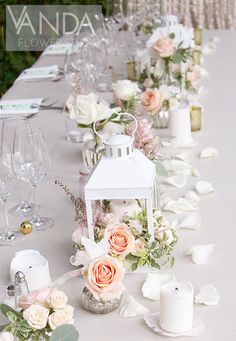 a long table with flowers and candles on it