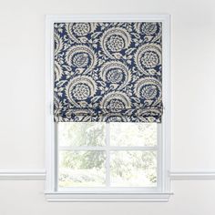 a window with a blue and white patterned valance