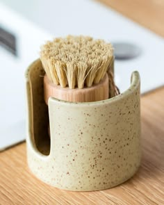 a close up of a brush in a cup on a table