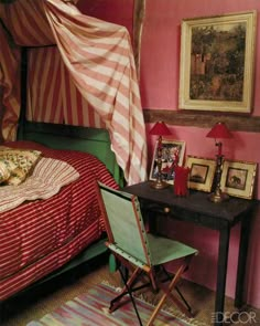 a bed room with a neatly made bed next to a desk and pictures on the wall