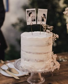 a wedding cake with two photos on top