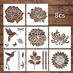 paper cut flowers and birds are arranged on a wooden surface with the numbers 8 - 9