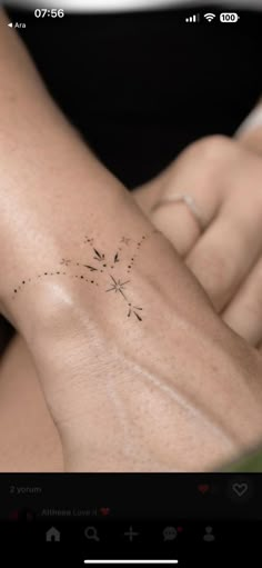 a woman's arm with a dandelion tattoo on it