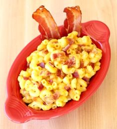 a red bowl filled with macaroni and bacon