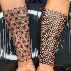 two people with tattoos on their arms and legs, both showing the same pattern as they hold hands