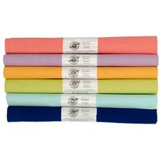 four different colored sheets stacked on top of each other in rows, with one folded over the