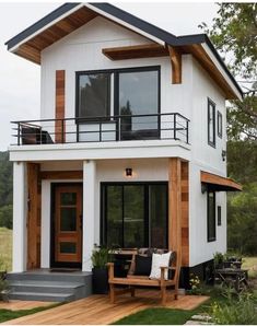 a white house with wood accents and balcony