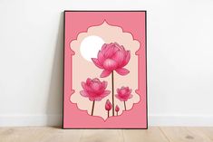 a pink poster with flowers on it in front of a white wall and wooden floor