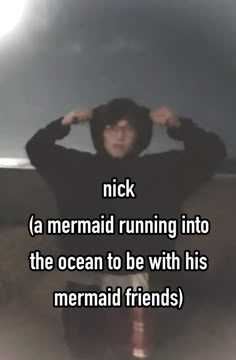 a man sitting down with his hands on his head and the words nick mermaid running into the ocean to be with his mermaid friends