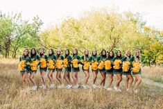 a group of girls in green and yellow cheerleader outfits